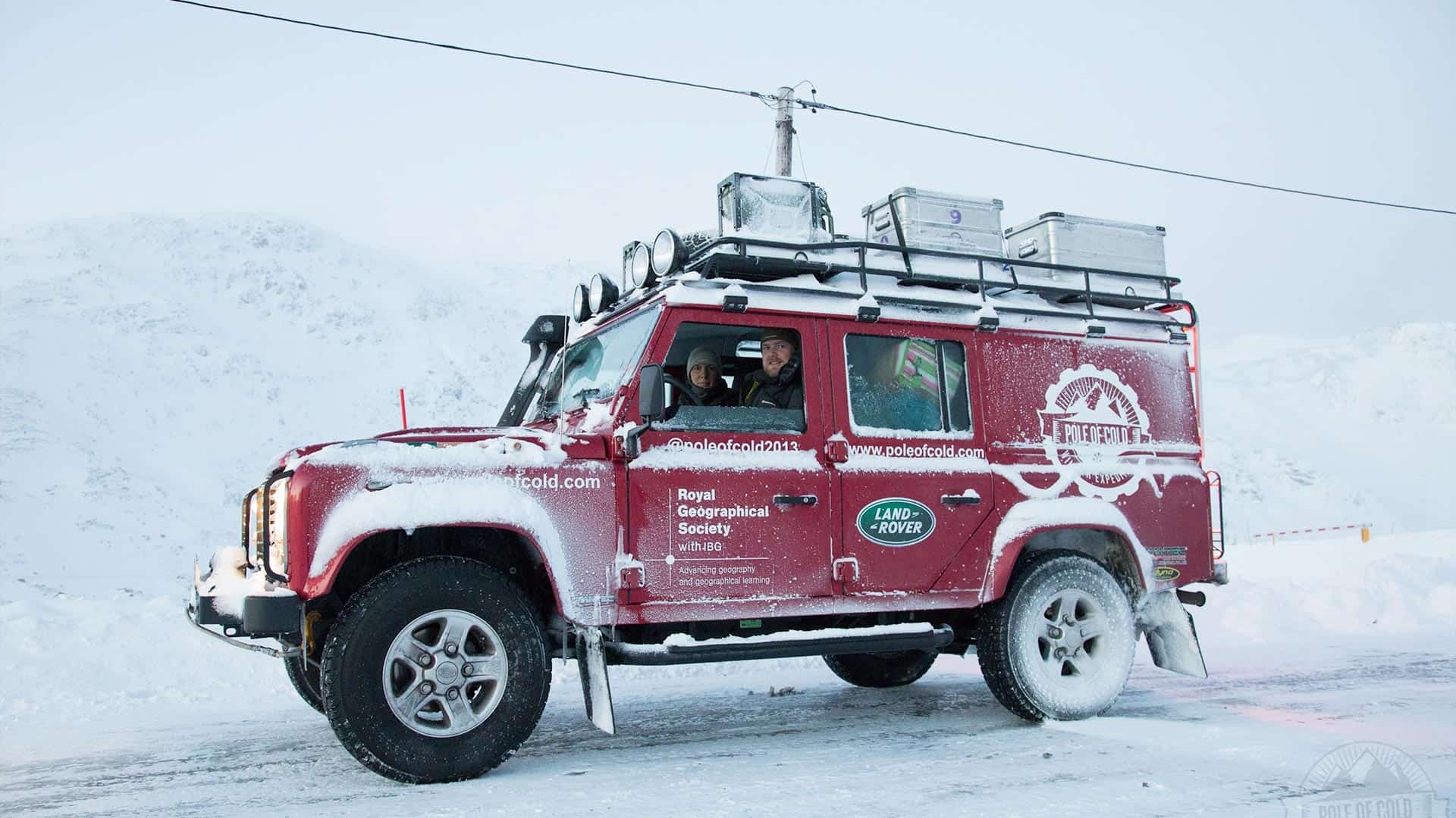 Land Rover Defender driving through heavy snowfall