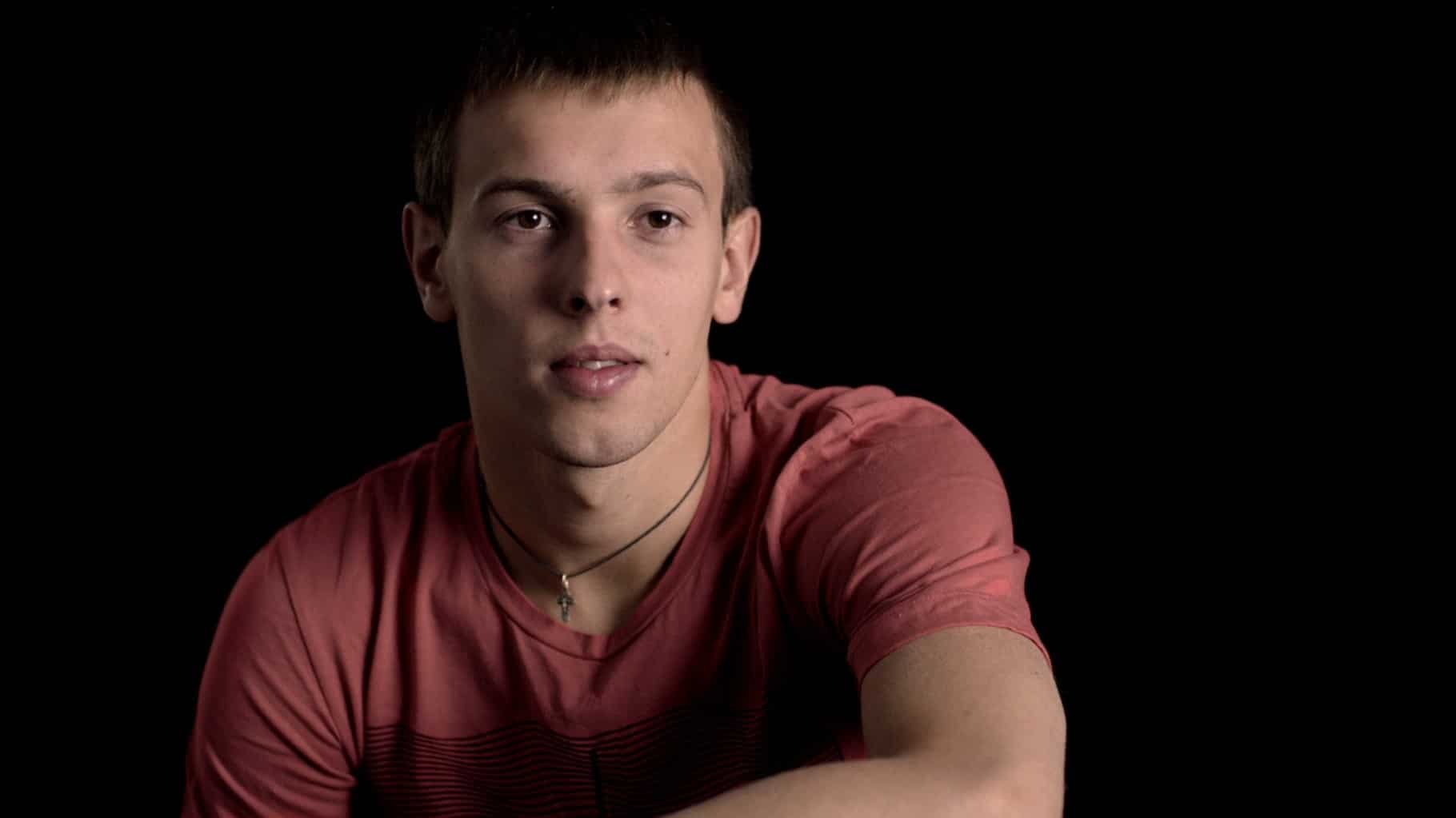 A person is in the picture with dark background 